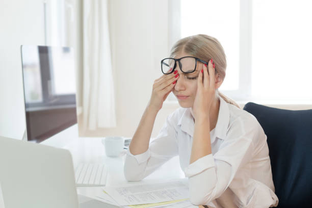 Frustrated person staring at a screen, feeling stuck and overwhelmed with programming challenges.