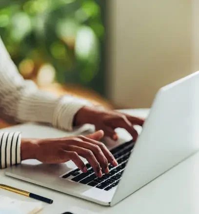 Hands confidently typing on a keyboard, symbolizing focus and determination in programming.